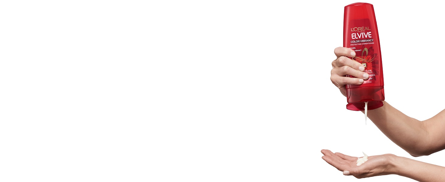 person holding shampoo Bottle